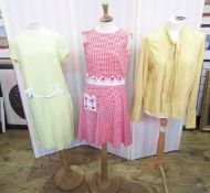A red and white check shift dress with applique daisy detail to the drop waist and to a single
