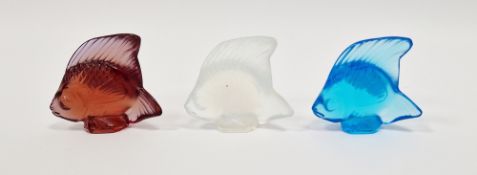 Three Lalique frosted glass fish models, in opal, red and pale blue, each signed and with their