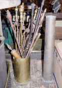 Two artillery shell cases, a selection of fireside tools, three brass fenders and a spark guard