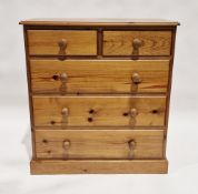 Modern pine chest of two short over three long drawers, each with turned wooden handles, 92cm high x