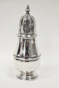A George VI silver baluster shape sugar caster, the pierced detachable cover with knop finial, the