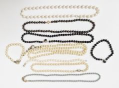 Three strings of grey/black pearls, similar bracelet, white cultured pearl necklace, two strings