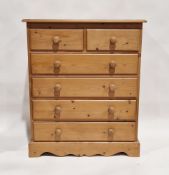 20th century pine chest of two short over four long drawers, each with turned handles, 104cm high