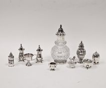A collection of five silver pepperettes, including Walker & Hall, Sheffield 1938; Deakin &
