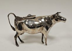 A Elizabeth II silver cow creamer, the hinged lid applied with a fly finial, the tail forming a