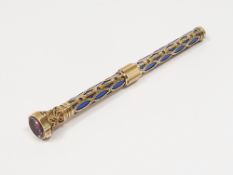 Gold-coloured metal and enamel propelling pencil set with stone to the end, foliate decorated and