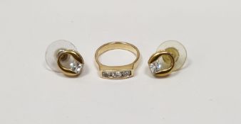 Gold-coloured and diamond three-stone ring, unmarked and a pair of gold-coloured and paste solitaire