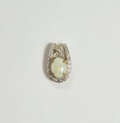 9K gold, opal and diamond pendant set oval opal with diamonds set to the borders