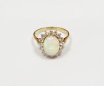 18ct gold, opal and diamond cluster ring, the oval opal surrounded by claw set diamonds, 3.7g approx