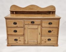 19th century pine low dresser with raised ledge back (later), seven short drawers arranged around