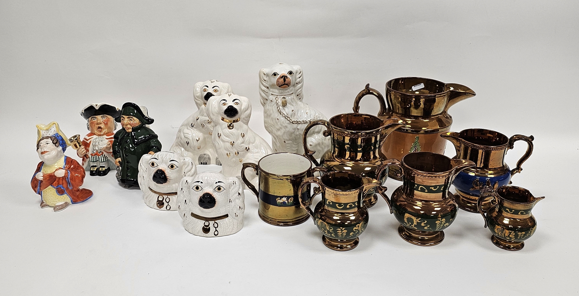 Collection of Staffordshire pottery including a group of copper lustre jugs, a two-handled loving