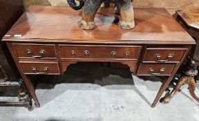 Reproduction mahogany veneer desk with central long drawer flanked by two short drawers on each