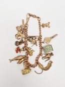 9ct rose gold curb link charm bracelet having multiple charms including jousting knight, fire
