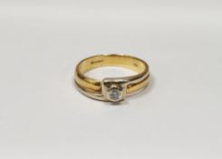 18ct gold solitaire diamond ring, the yellow and white geometric crossover setting having single