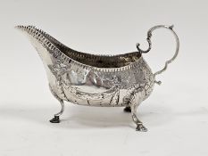 George III Irish silver sauceboat by Matthew West, Dublin (no date letter), decorated with garlands,