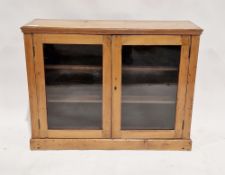 Victorian pine display cabinet, the two glazed doors opening to reveal two adjustable shelves,