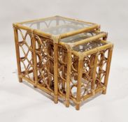 Nest of three stained bamboo and wicker side tables with glass tops, largest 54cm high x 50cm wide x