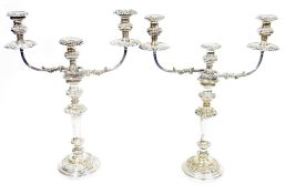 Pair of silver plated candelabra, each three light with removable foliate scroll drip trays, waisted