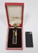 Cartier gold-plated and black enamel lighter of square section, boxed, and a Prince Racing 45 slim-