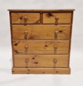 20th century pine chest of two short over three long drawers, each with turned handles, 93cm high