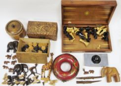 An early 20th century folding chess/backgammon board with pieces, a selection of carved wooden