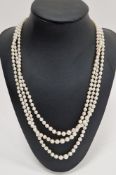 LOT WITHDRAWN Triple string of graduated pearls with 9ct gold, pearl and garnet clasp