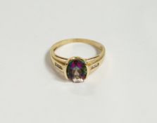 Gold-coloured metal and 'mystic' topaz ring set oval stone and small diamonds to the shoulders