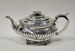 A George III silver boat shape demi gadrooned teapot, gadrooned hinged cover with oval foliate