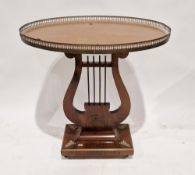 An Empire-style occasional table, of oval form, with pierced brass gallery raised on lyre-shaped