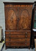 Sheraton period mahogany linenpress with fitted sliding trays and enclosed by a pair of oval panel