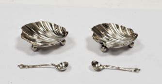 Pair late Victorian silver salt cellars, each shell-shaped and raised on three ball feet and a