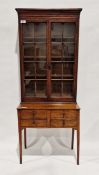 Late 19th/early 20th century bookcase on stand/desk, the two glazed doors opening to reveal three