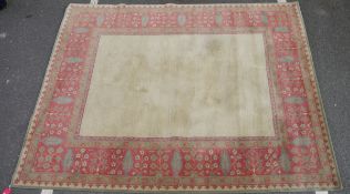 Large wool carpet of revived Eastern style, having stiff leaf and floral spray iron red border and