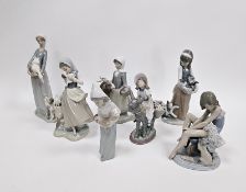 Seven Lladro figures of girls with animals including a ballerina with cat, a girl cradling
