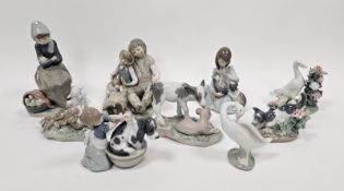 Nine Lladro figures of girls, boys and animals including a girl with kitten and puppy, another