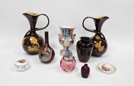 Pair of Bretby Art pottery vases of bulbous whiplash form, decorated with birds perched amongst