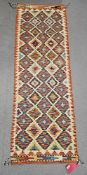 Chobi kilim cream ground runner, with three rows of ten and two rows of nine lozenges, flanked by