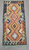Chobi kilim orange ground runner, with four central stepped lozenges, single geometric wave