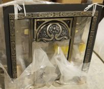 Cast iron fire surround with a fitted grate, 100cm wide approx.