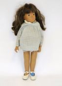 Original 1960's Sasha doll, brunette hair and clothed in a blue gingham outfit, 42cm high