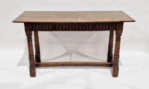 Oak table in the 17th century manner, the rectangular top over a thumbnail carved frieze with