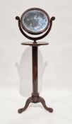 19th century mahogany shaving stand, the moulded framed swing circular mirror held on a carved