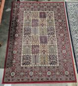 Persian red ground wool pile rug with twenty-four rectangle chequered field depicting twelve