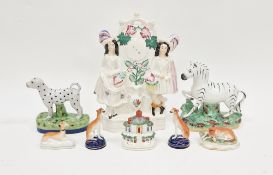 Pair Staffordshire model greyhounds, each on a blue circular plinth base, 11cm high, two similar