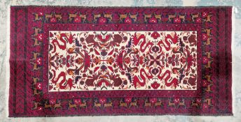 Afghan hand knotted rug showing animals on a cream background with oranges, reds, blue and green,