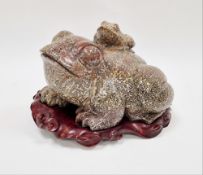 Chinese leopardskin jasper carving of a large bullfrog with a small frog on its back, on a