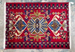 Fine hand knotted Iranian rug of exceptional quality, red background with green, blue, cream and