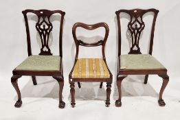 A pair of mahogany dining room chairs in the George lll manner with pierced curved splats, drop in