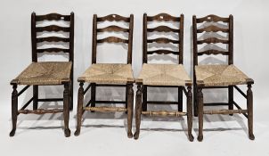 Set of four Lancashire-style ash ladderback chairs with rush seats (one chair with ladder slat
