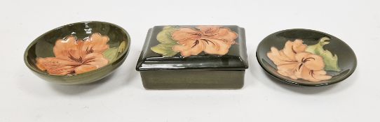 Moorcroft pottery lidded rectangular box, coral hibiscus pattern on a green ground, 13cm wide, and